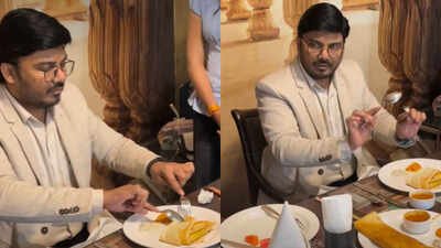 man teaches eating dosa with fork