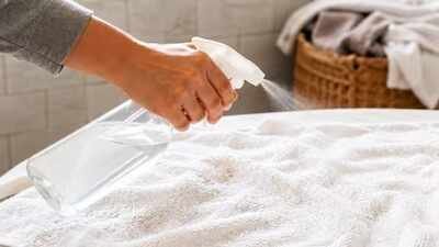 spraying white vinegar on towels