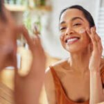 woman using sunscreen