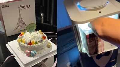 man wakes up to a birthday cake delivered by a robot at a hotel
